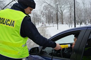 Policjant WRD sprawdza trzeźwość kierowcy, aura zimowa