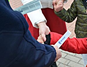 Policjanci przekazują dzieciom elementy odblaskowe