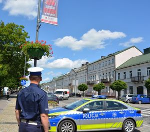 Policjant i radiowóz w centrum miasta
