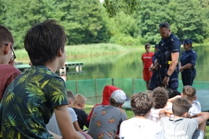 Policjanci rozmawiają z turystami nad jeziorem