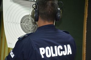 policjant sprawdza wyniki strzelania na tarczy