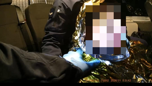 policjanci udzielający pomocy osobie której groziło zamarznięcie